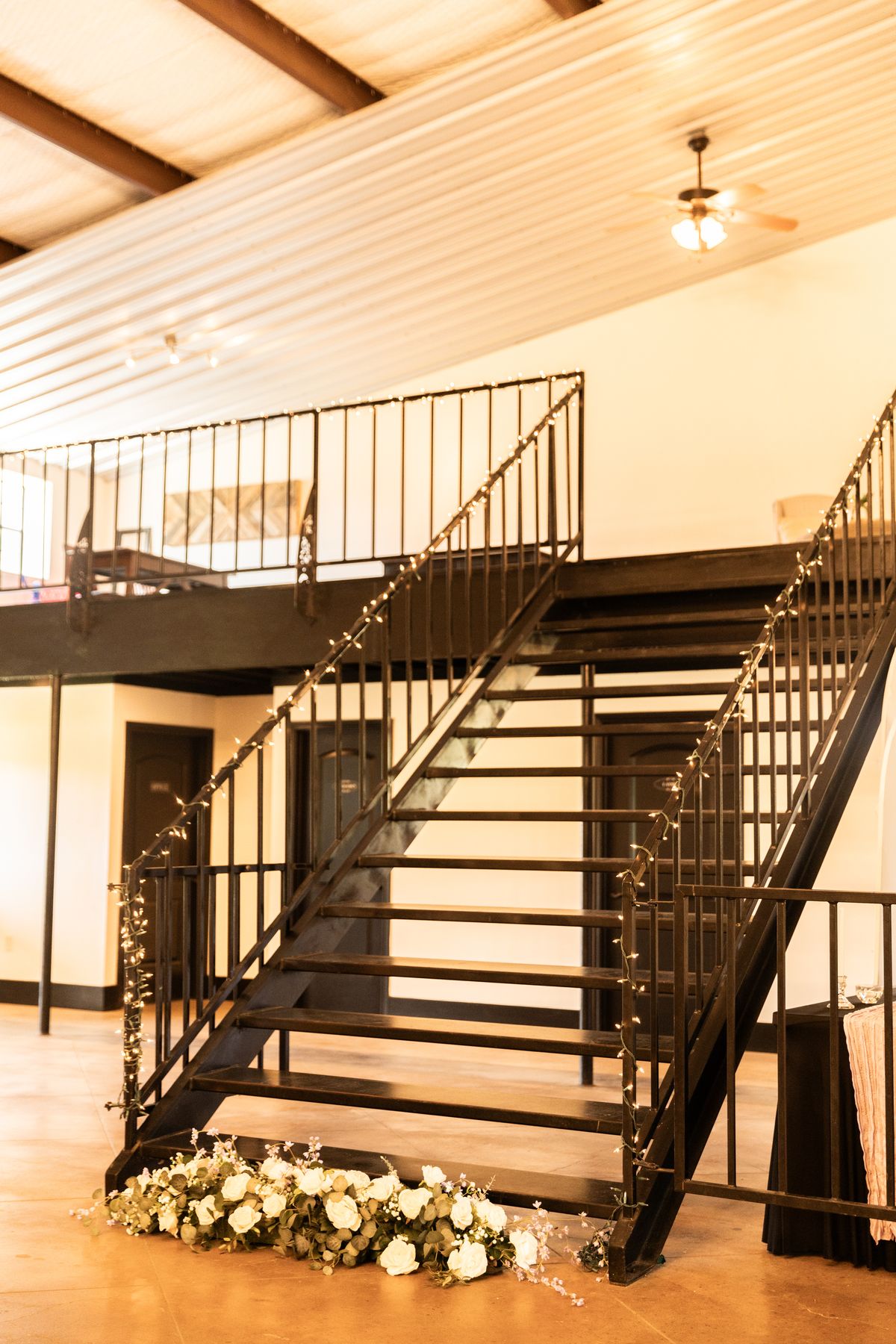 Grand staircase with white florals inside Heritage Hall