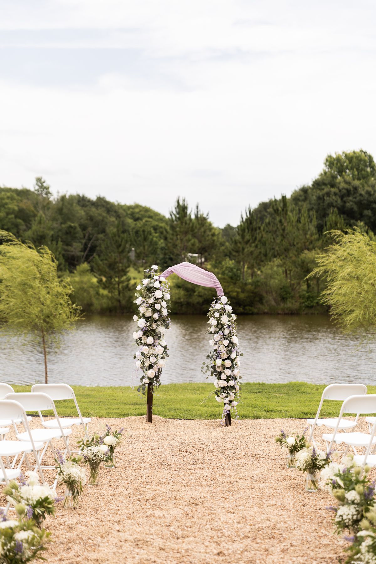 Floral ceremony arch overlooking the lake at Heritage Hall